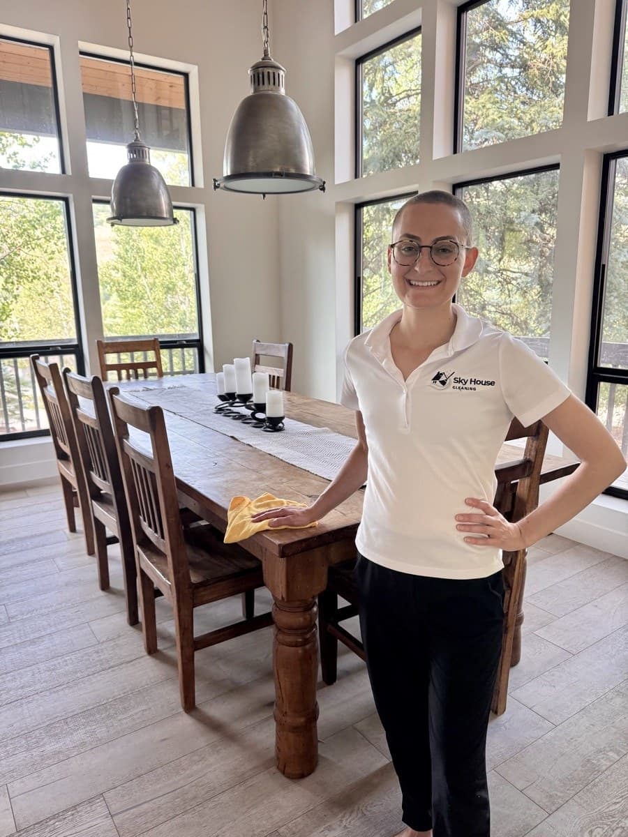 Sky House Cleaning house cleaner in uniform cleaning a dining room table