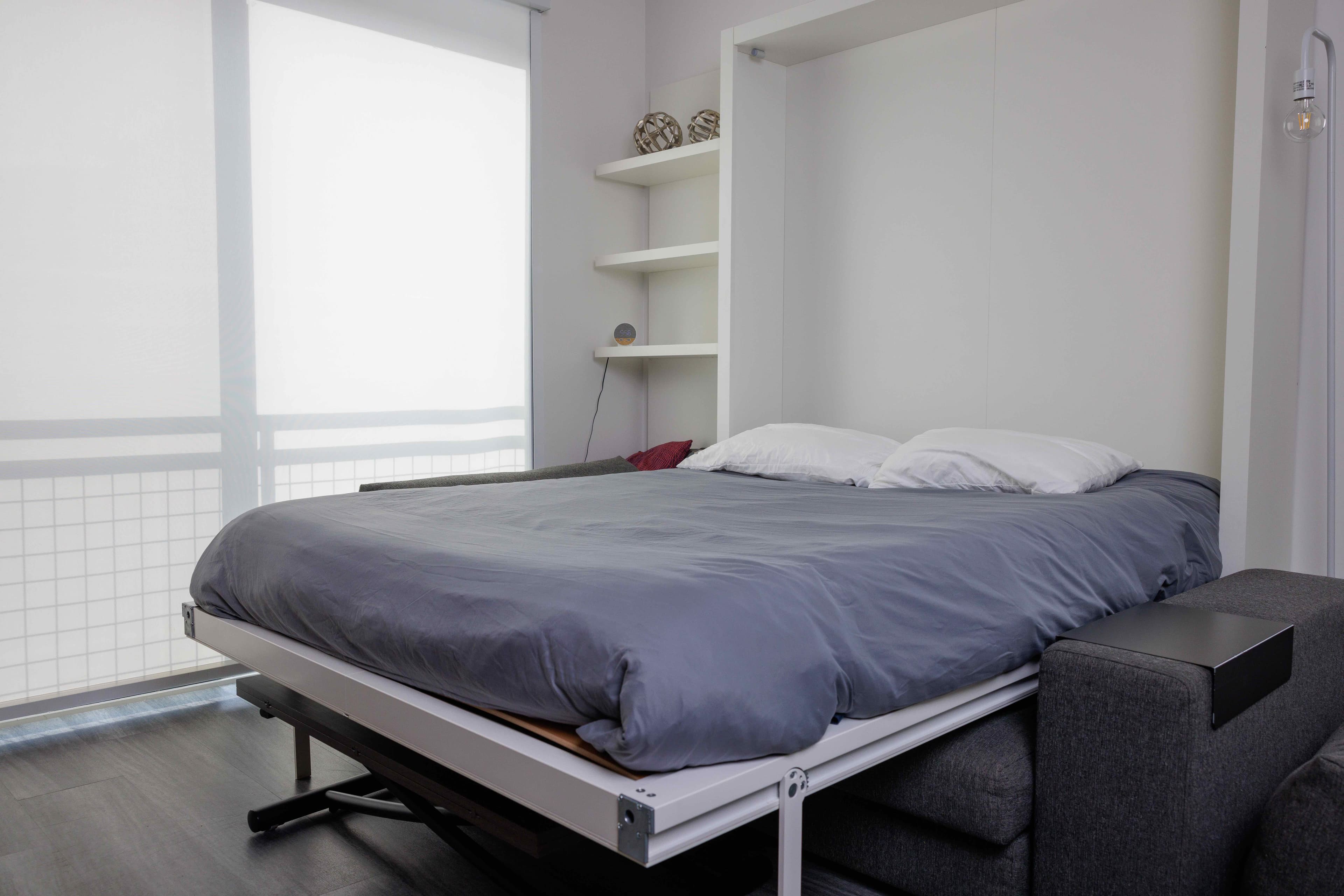 Airbnb bedroom with a neatly made fold-down bed