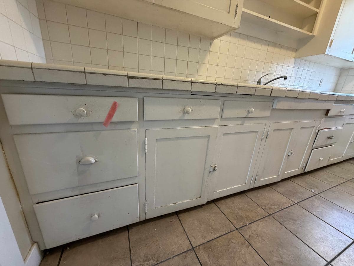 Kitchen cabinets cleaned by Sky House Cleaning, before