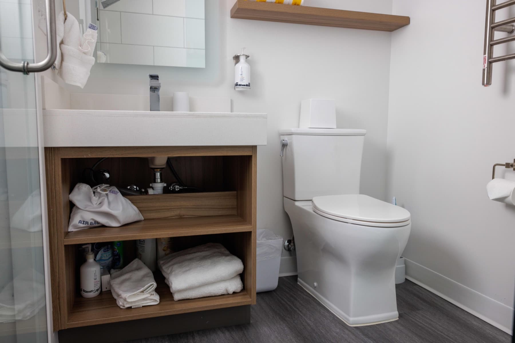 Clean bathroom vanity with folded towels and a spotless toilet in a Park City condo