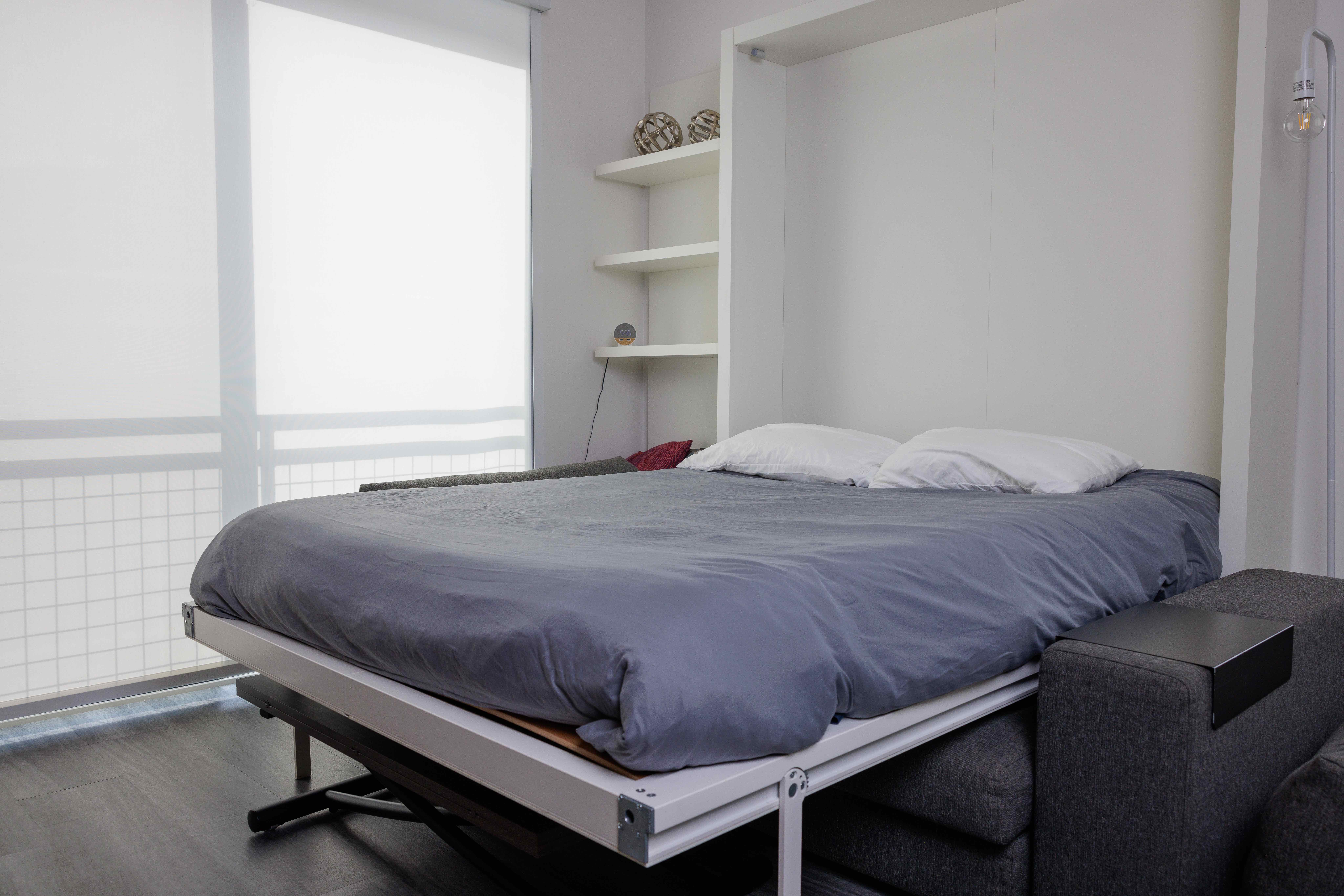 Airbnb bedroom with a neatly made fold-down bed
