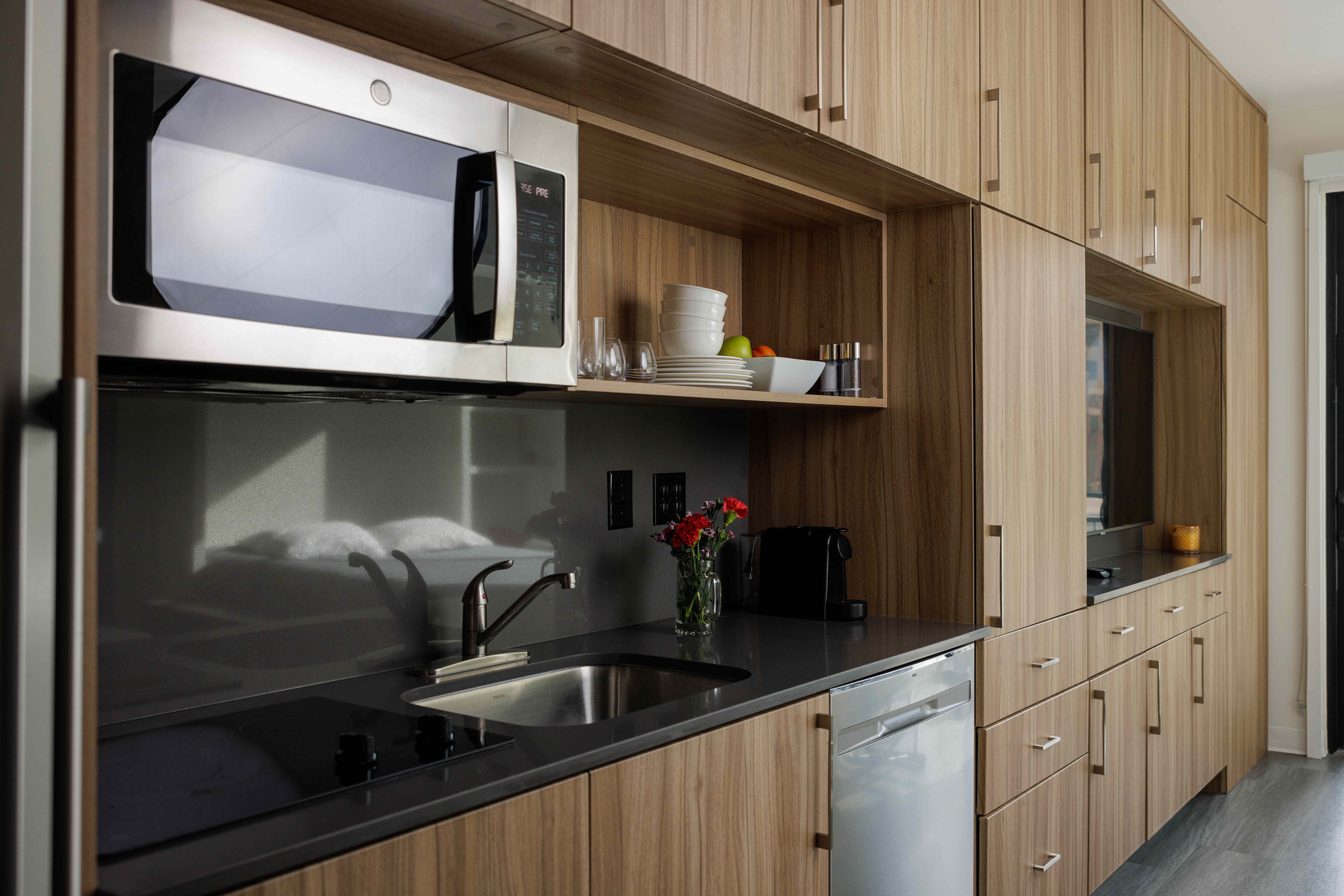 Fully stocked Airbnb kitchen with wood cabinetry, ready for the next guest