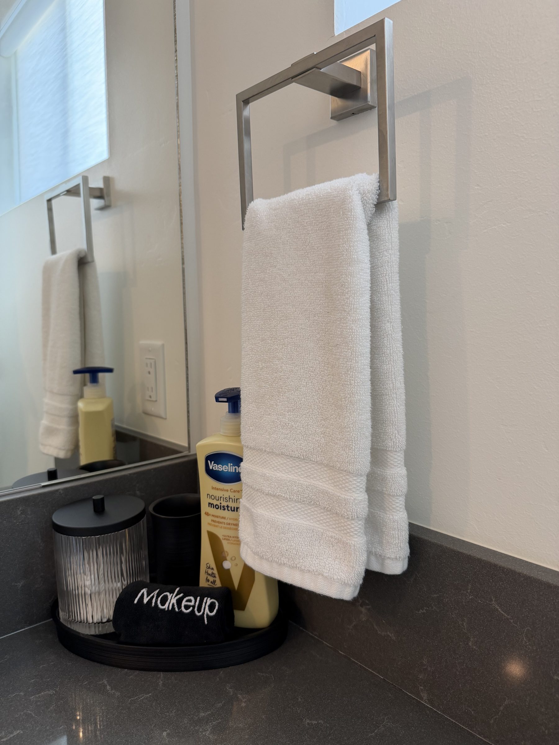 Neatly hung towels and an organized bathroom counter